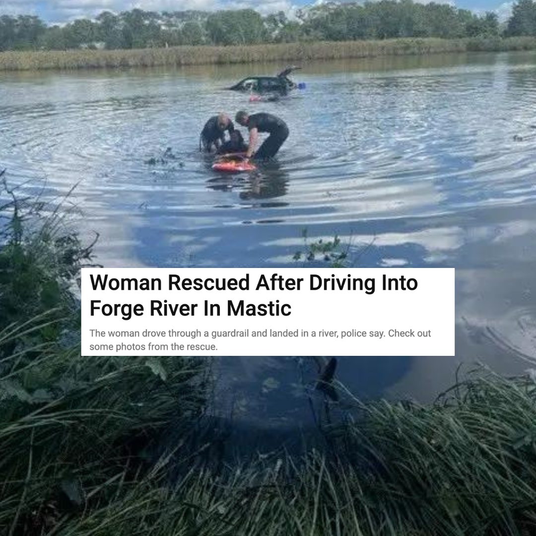 A woman is being rescued from a river after driving into it.