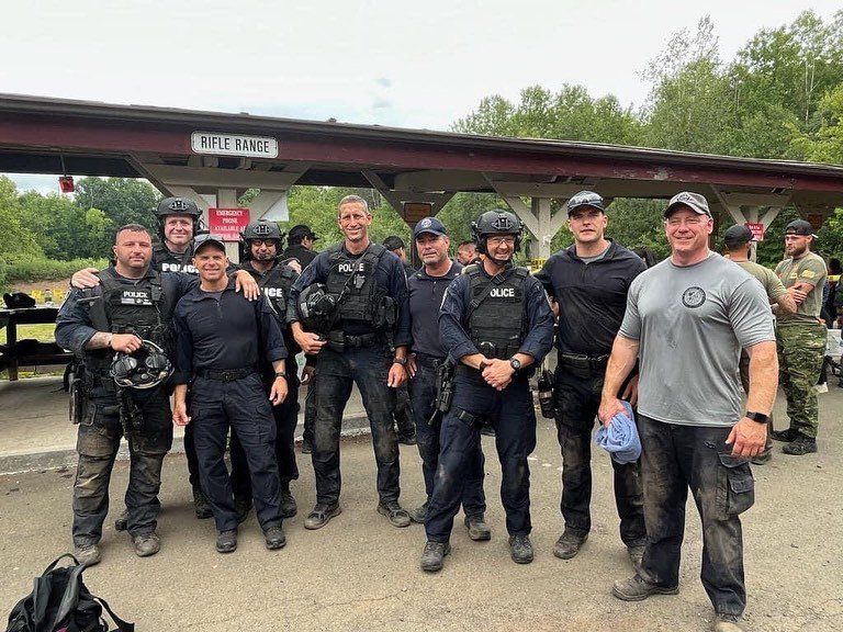 A group of police officers are posing for a picture