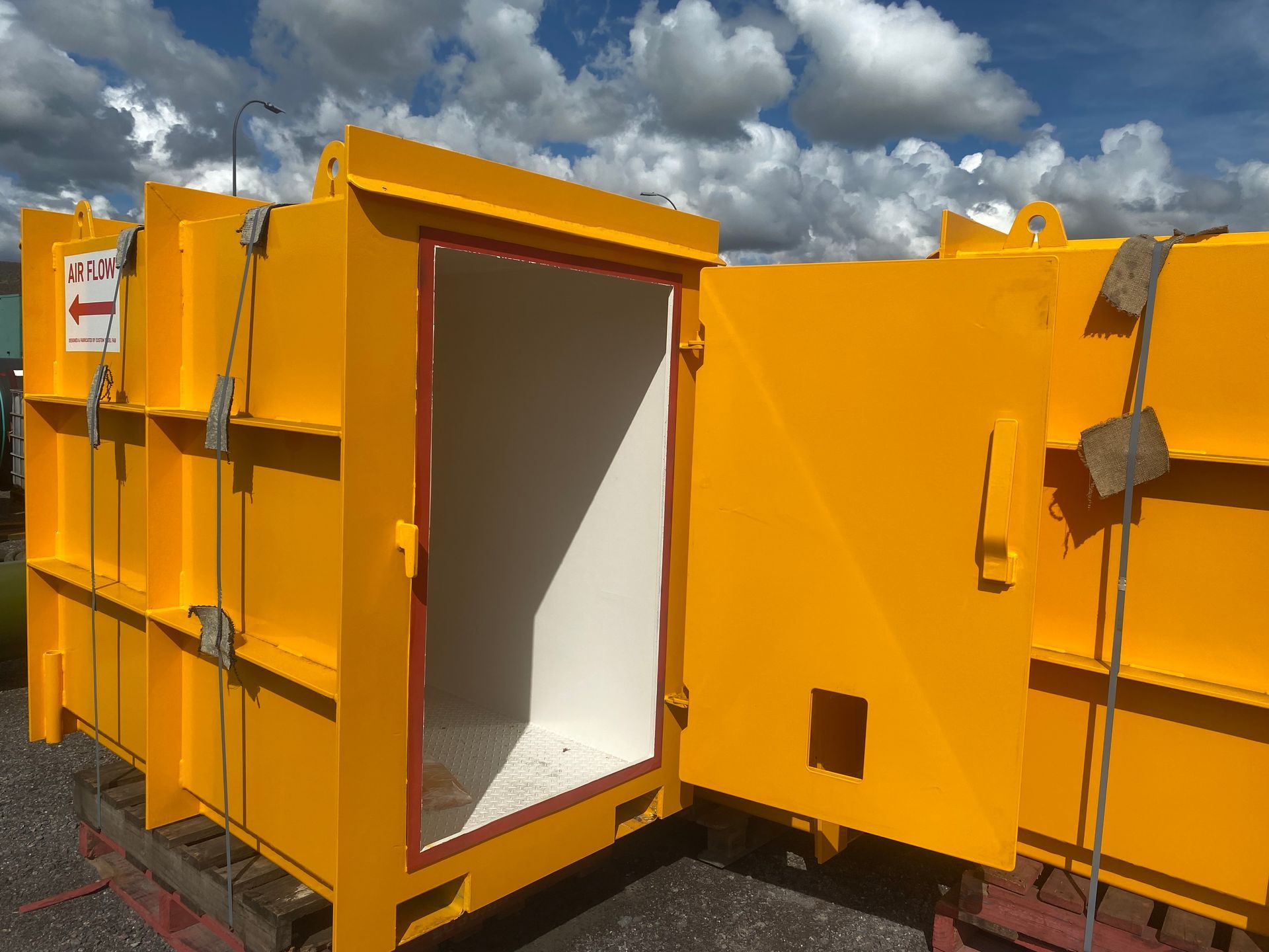 Open Yellow Metal Container With White Interior and Side Door Outdoors — Vent Doors Australia in Bohle, QLD