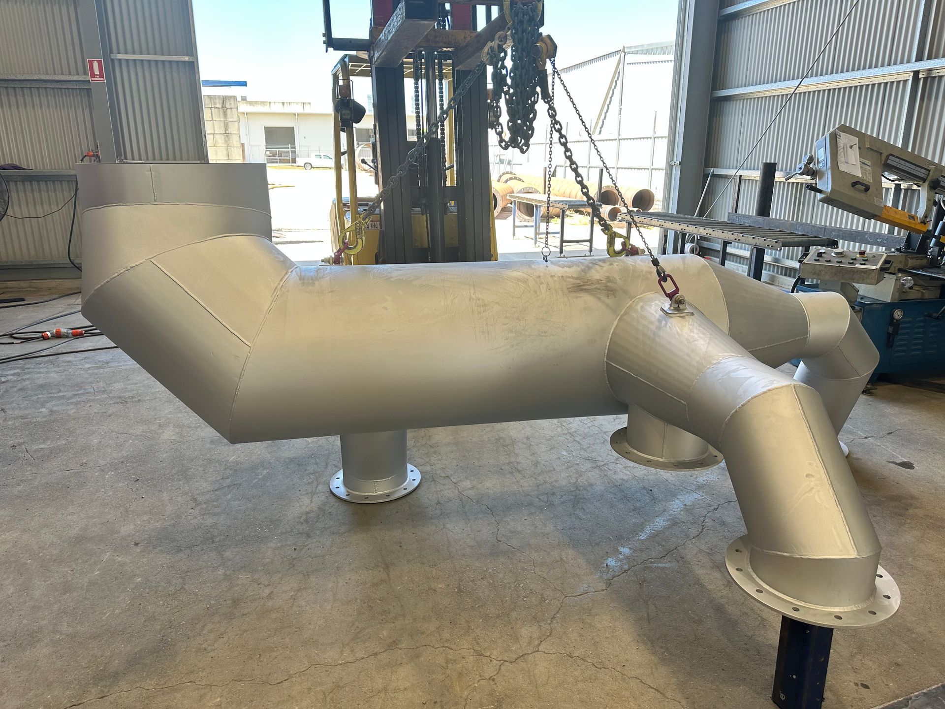 Large Insulated Metal Industrial Pipe Assembly in a Factory Setting — Vent Doors Australia in Bohle, QLD