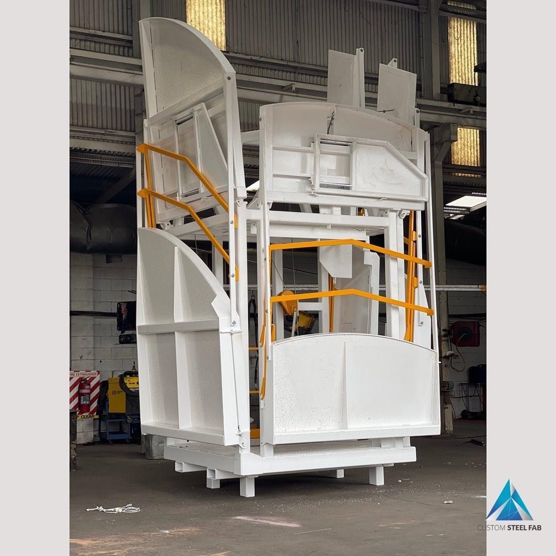 Large White Industrial Equipment With Orange Railings Inside a Warehouse — Vent Doors Australia in Bohle, QLD