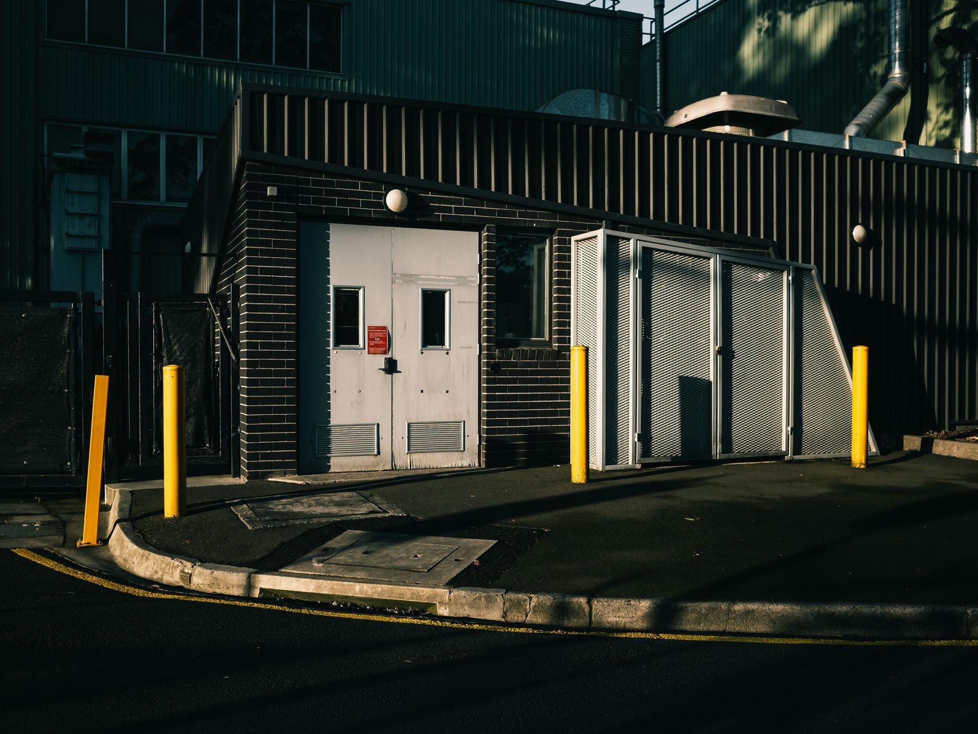 Dark Industrial Building Entrance With White Doors — Vent Doors Australia in Bohle, QLD