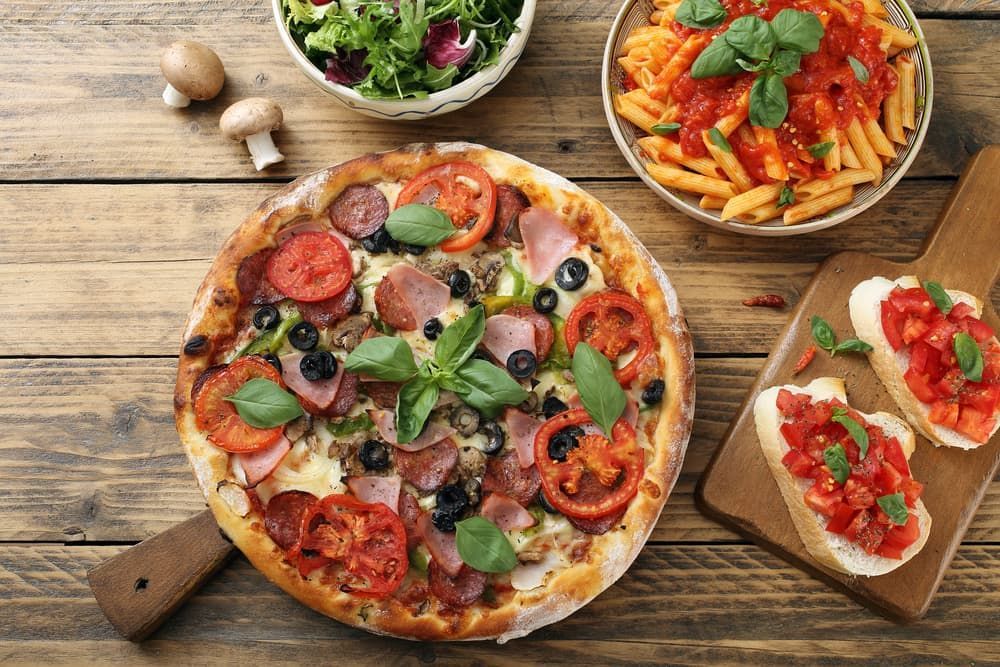 Top View Pizza Pasta With Tomato Sauce And Salad Bowl On Rustic Table — Pacific Palms Bowling Club In Smiths Lake, NSW