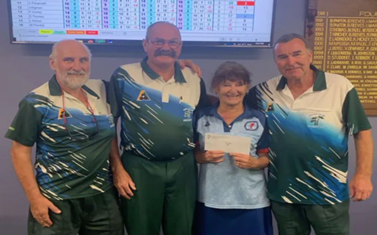 A Group Of People Standing Next To Each Other Holding A Check — Pacific Palms Bowling Club In Smiths Lake, NSW