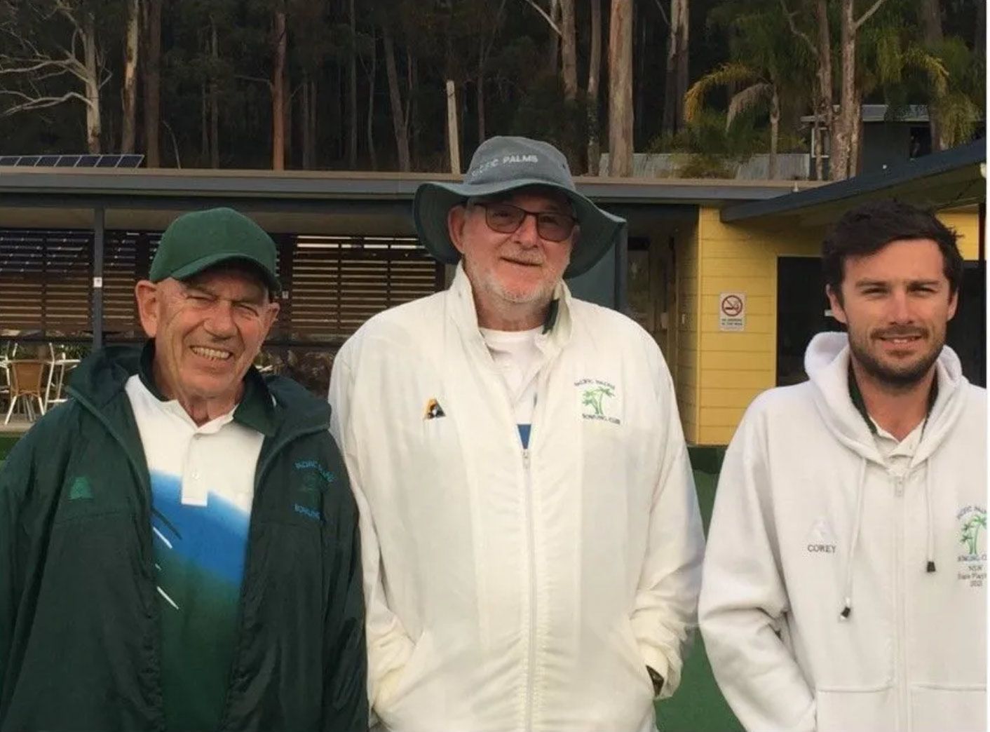 Three Men Are Standing Next To Each Other In Front Of A Building — Pacific Palms Bowling Club In Smiths Lake, NSW