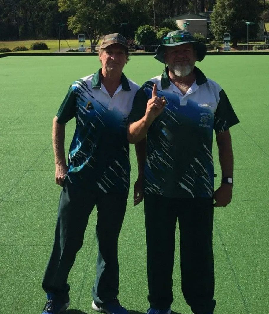 Two Men Standing Next To Each Other On A Green Field Giving A Thumbs Up — Pacific Palms Bowling Club In Smiths Lake, NSW