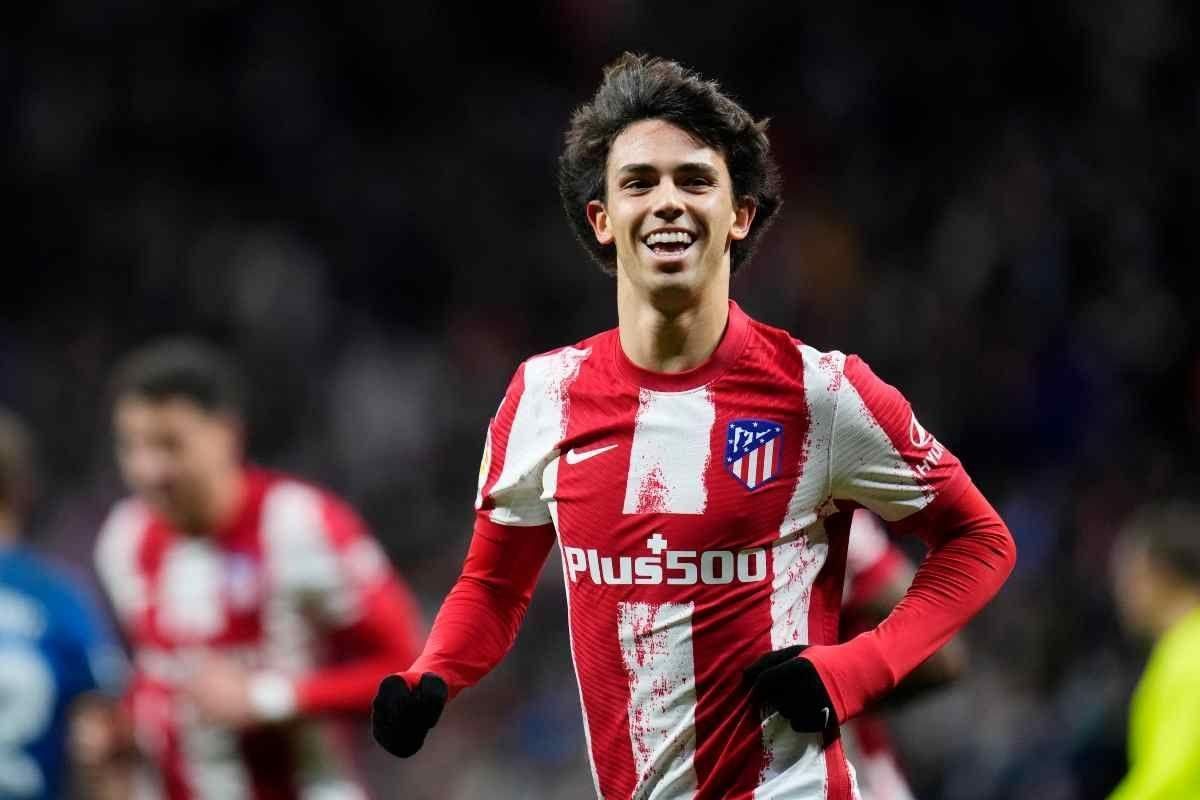 Soccer player in red-and-white striped jersey smiling on the field