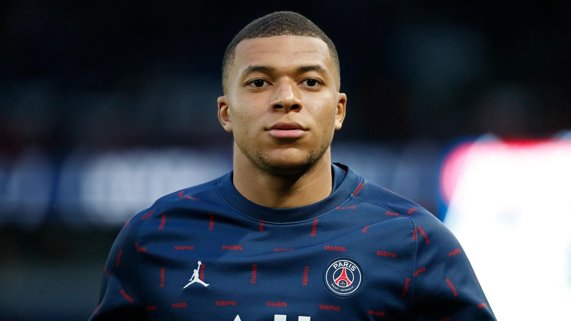 Paris Saint-Germain player in a navy training jersey, facing forward on the pitch