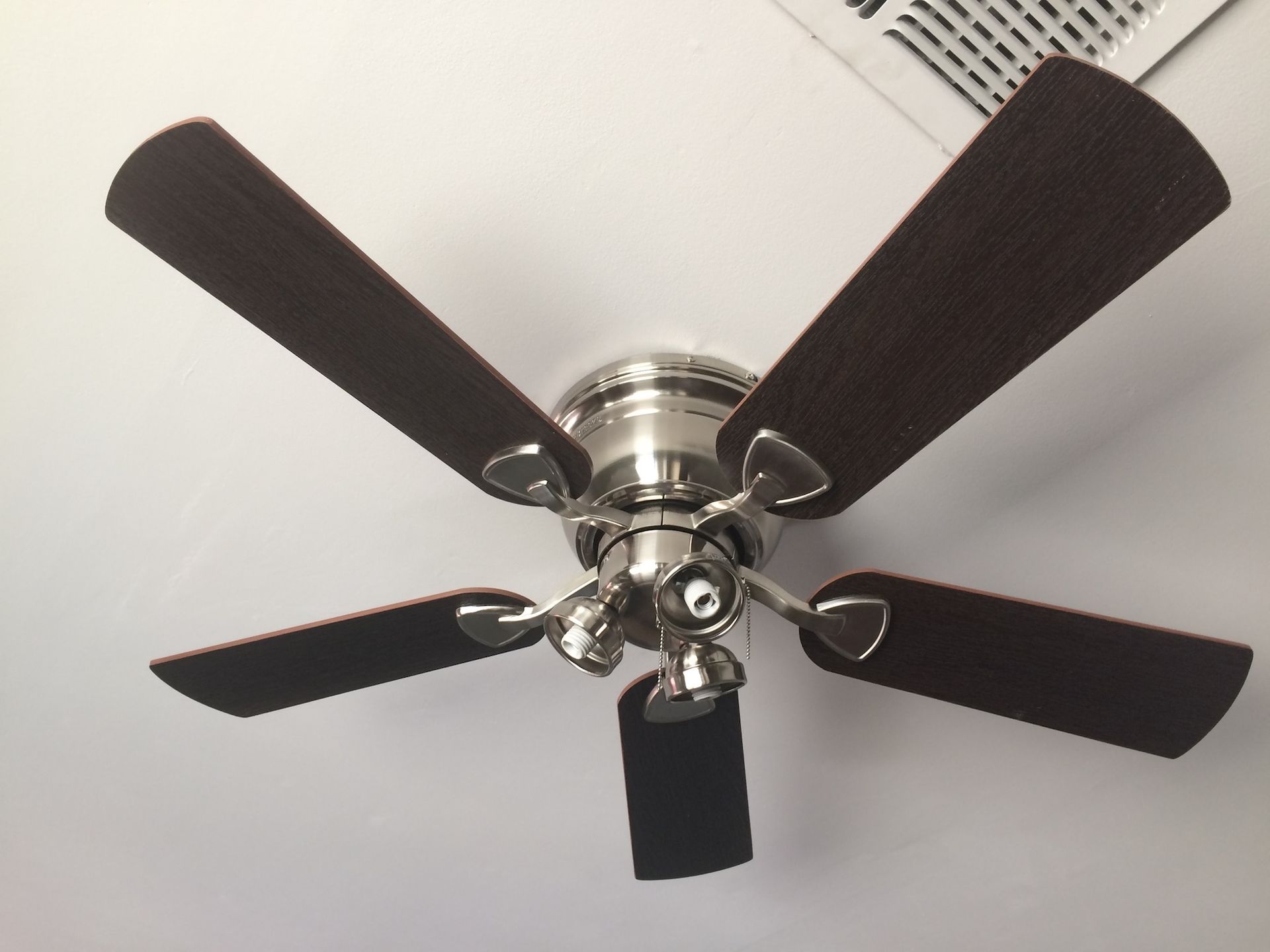 Ceiling fan with dark brown blades and a silver fixture.