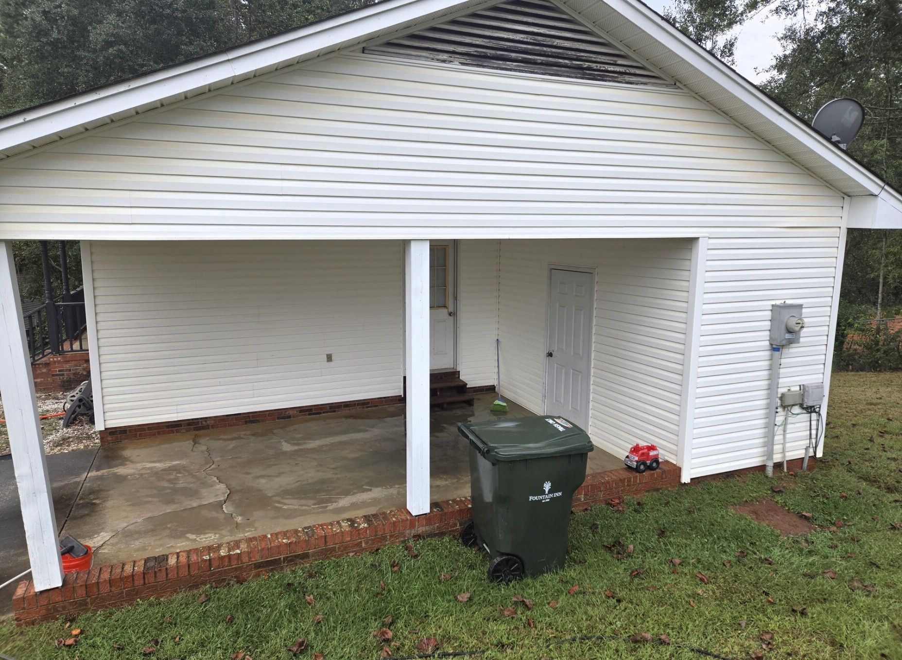 Power washing a wooden deck, removing dirt and grime.