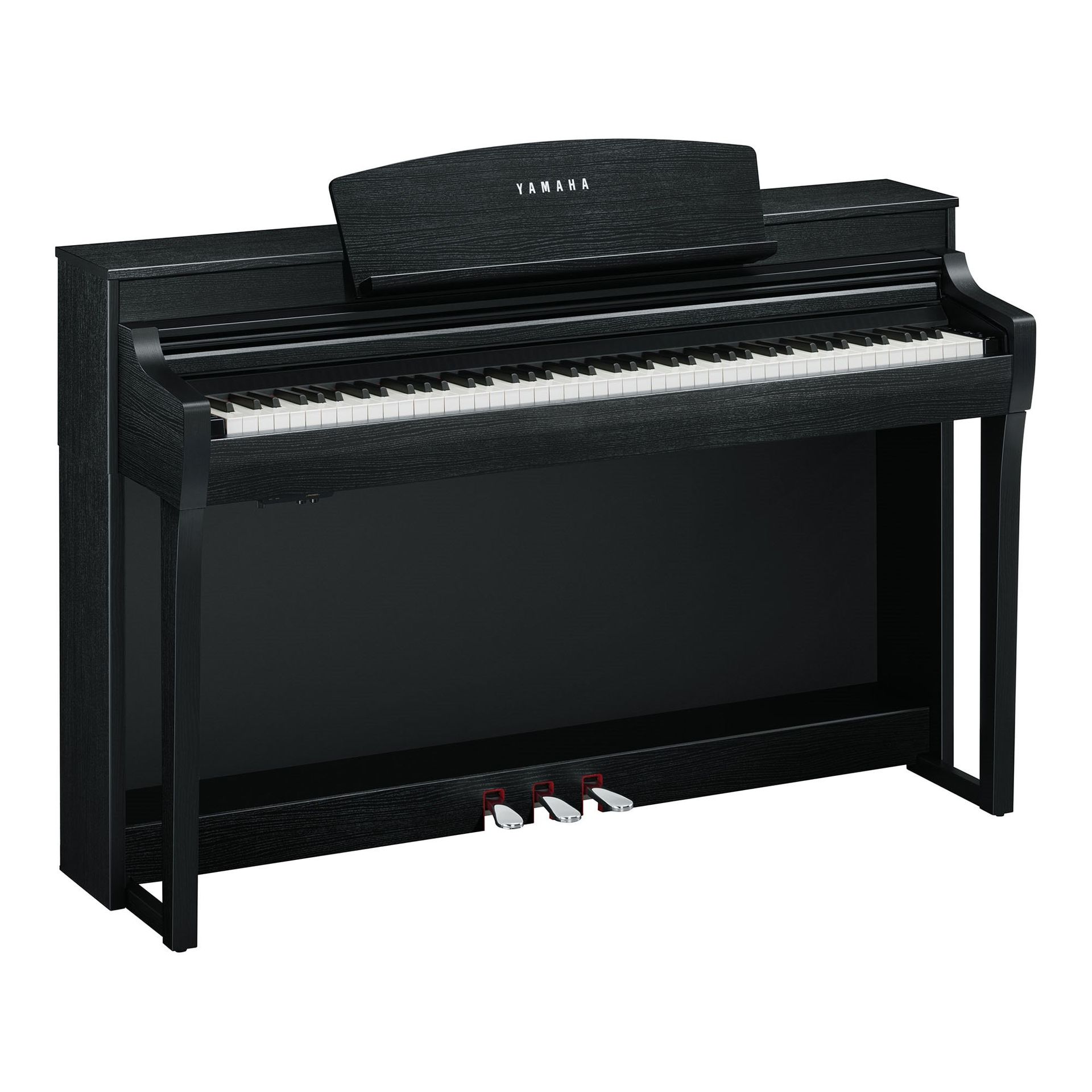 A black yamaha digital piano is sitting on a white surface.