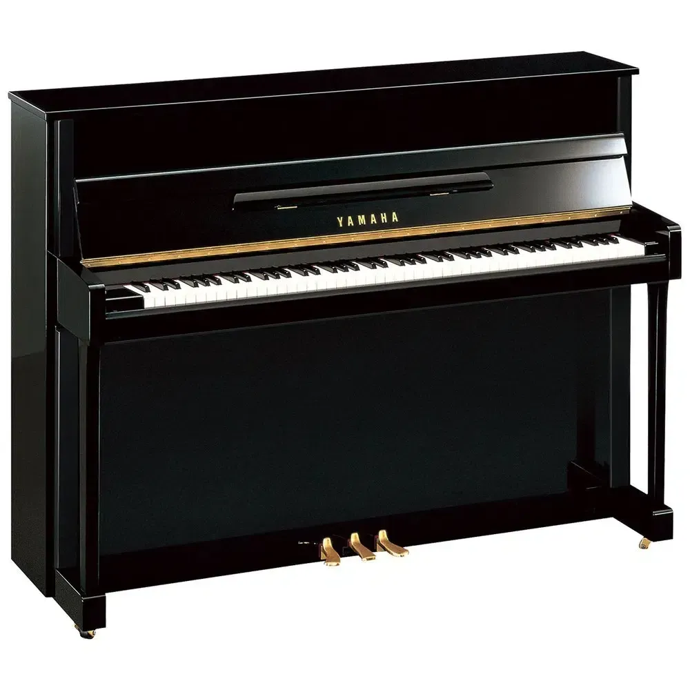 A black upright piano is sitting on a white surface.