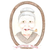 Illustrated portrait logo of an elderly woman with gray hair and a pipe, framed in an oval with “Wilderness Mama” text