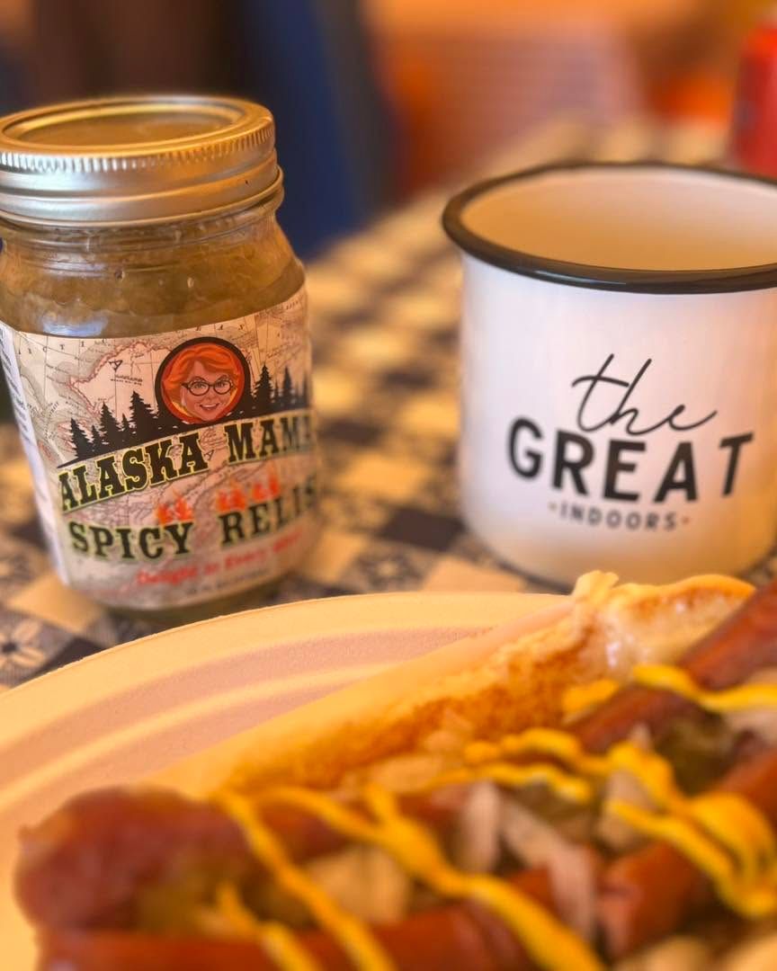 Jar of Alaska Habanero Spicy Relish beside a white “the GREAT outdoors” mug and a hot dog with mustard.