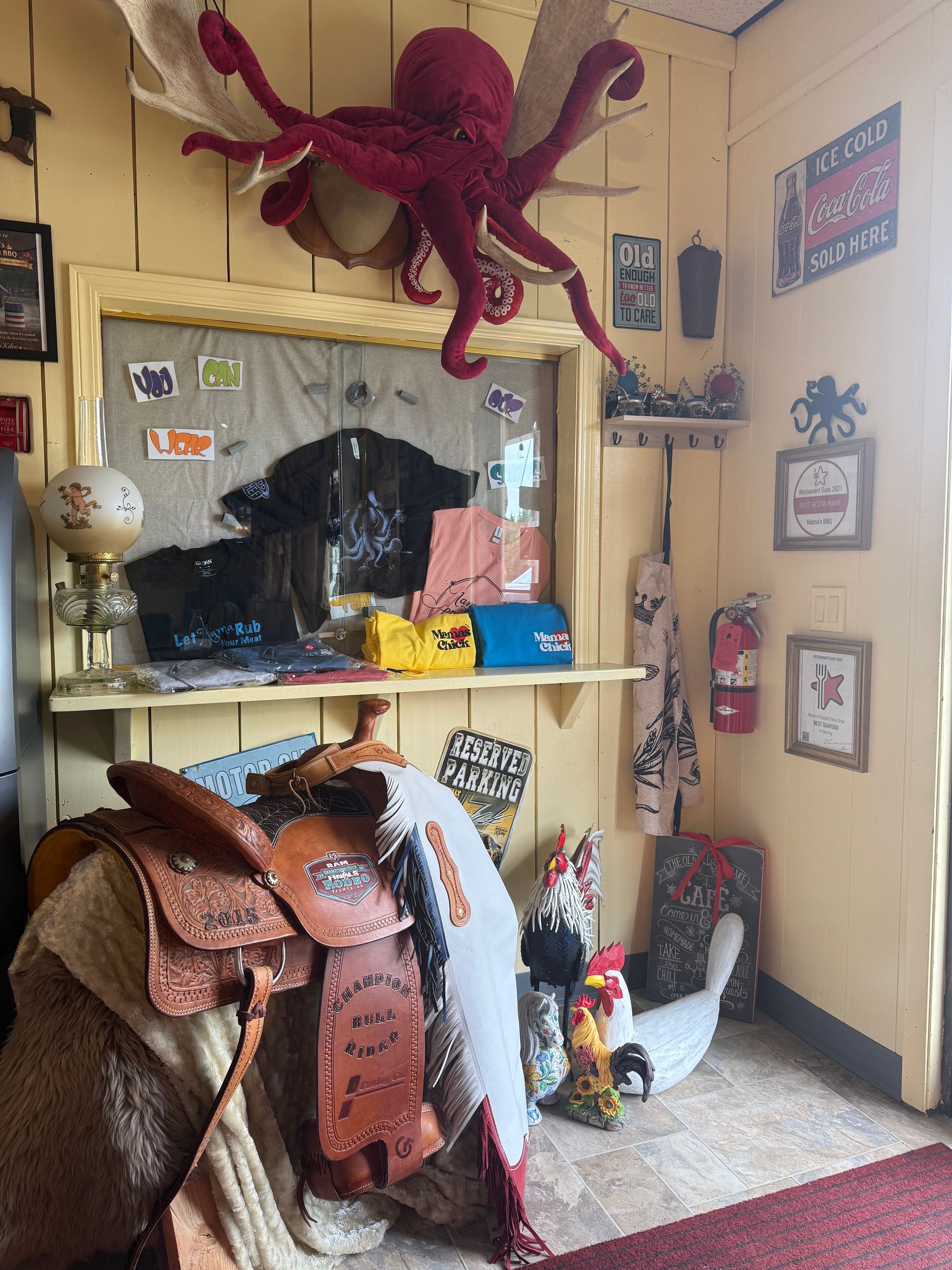 Gift shop corner with large red octopus decoration, shelves of souvenirs, and animal hats and trinkets