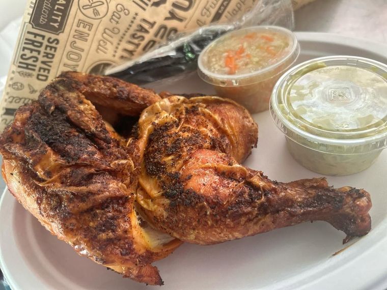 Grilled chicken with two dipping sauces on paper-lined tray
