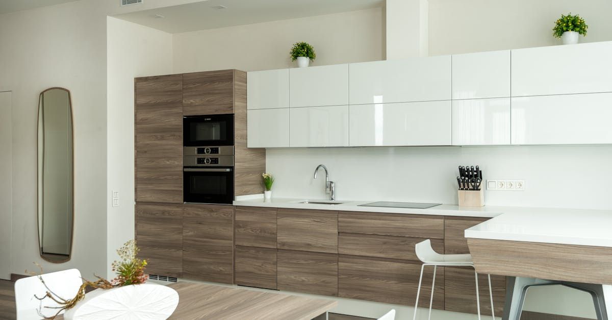 A kitchen with wooden cabinets and white counter tops