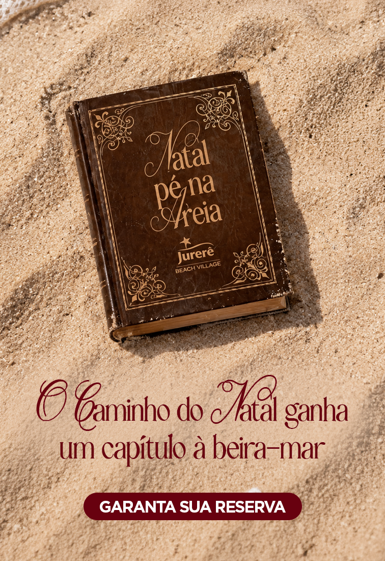 Livro marrom na areia com o texto “Natal para Areia” e a chamada “O caminho de Natal ganha um capítulo à beira-mar”