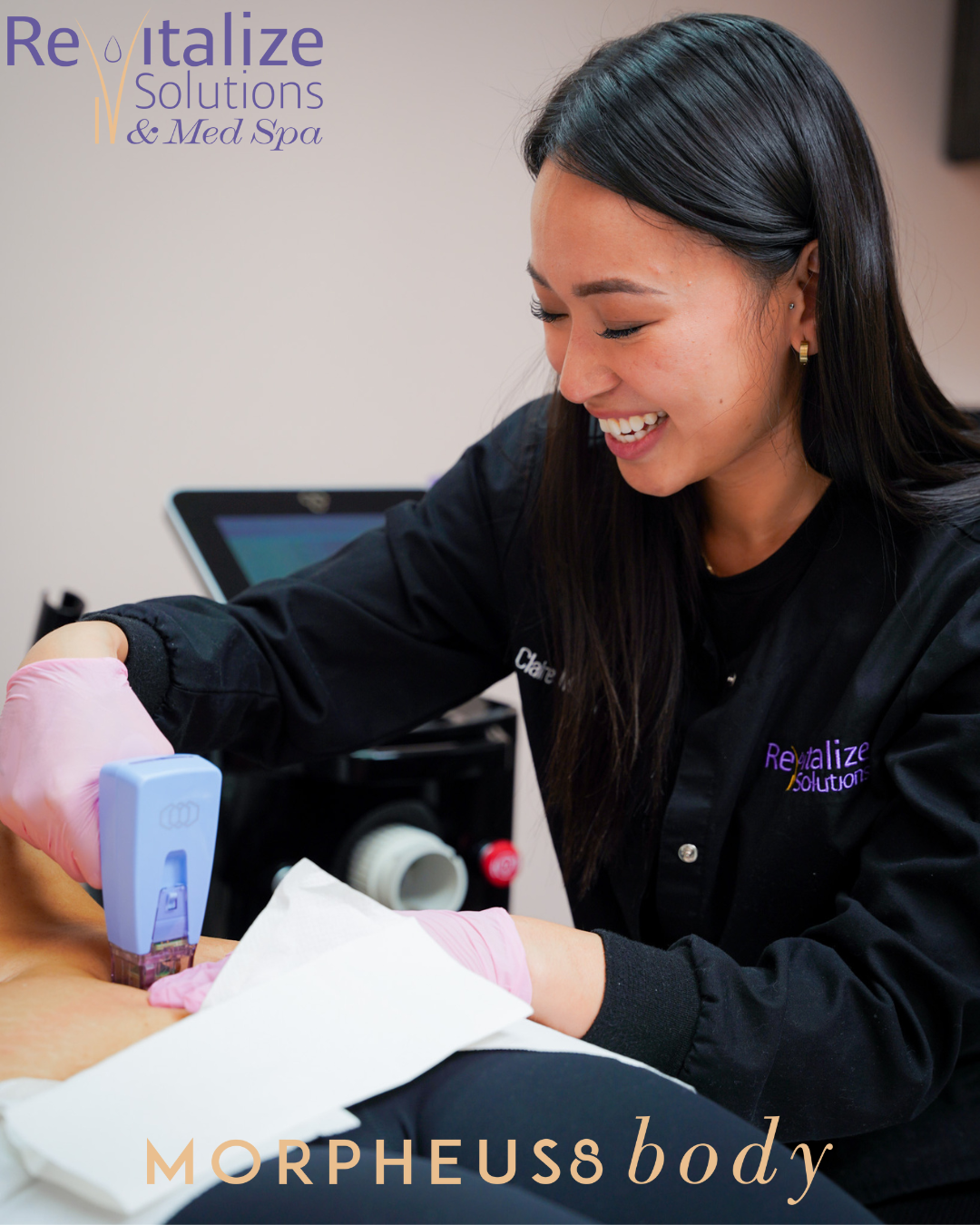 A woman is smiling while using a machine at morpheus body