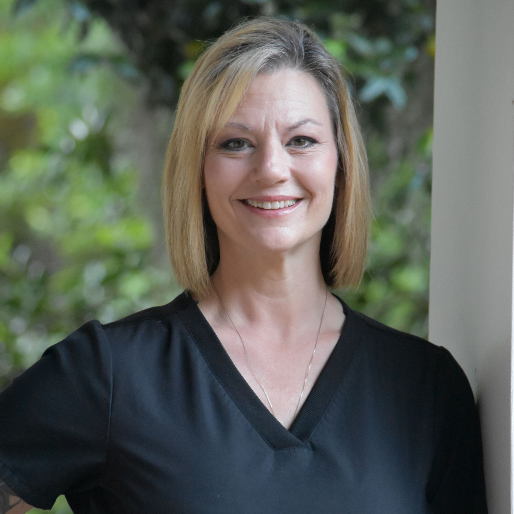 Smiling blonde woman against a black background