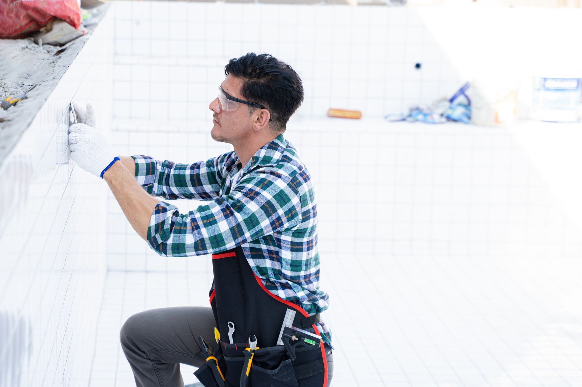 A worker is working in a swimming pool under construction. A worker is working in a swimming pool under construction.