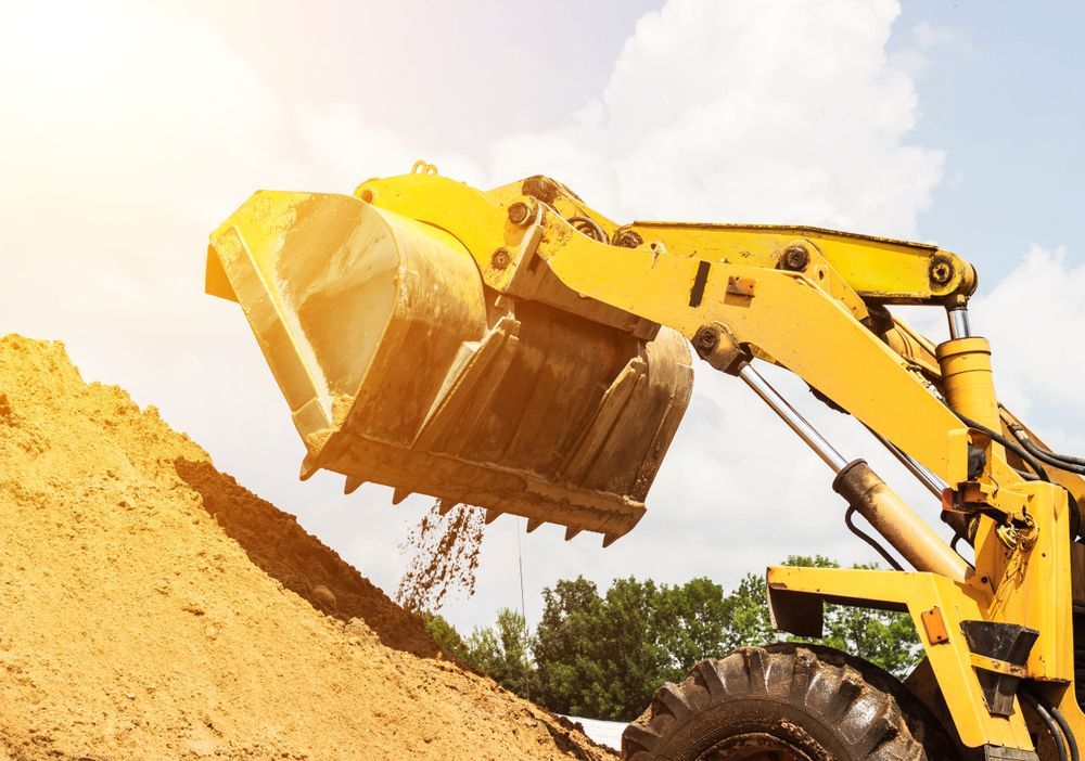 Yellow Backhoe Dumping Dirt, Sunny Outdoor Scene — Mears Construction & Training Pty Ltd in South Johnstone, QLD