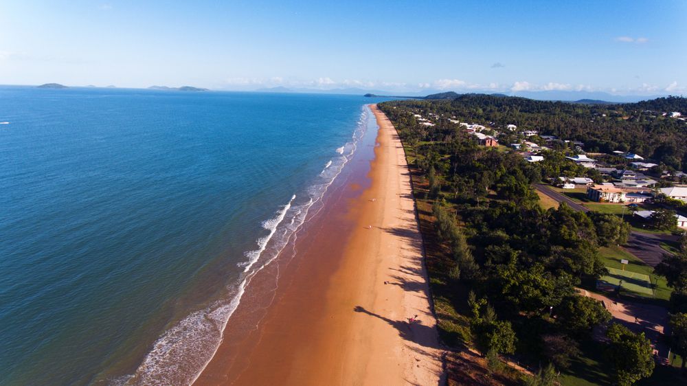 Aerial View Of A Sandy Beach, Calm Blue Ocean — Mears Construction & Training Pty Ltd in Mission Beach, QLD