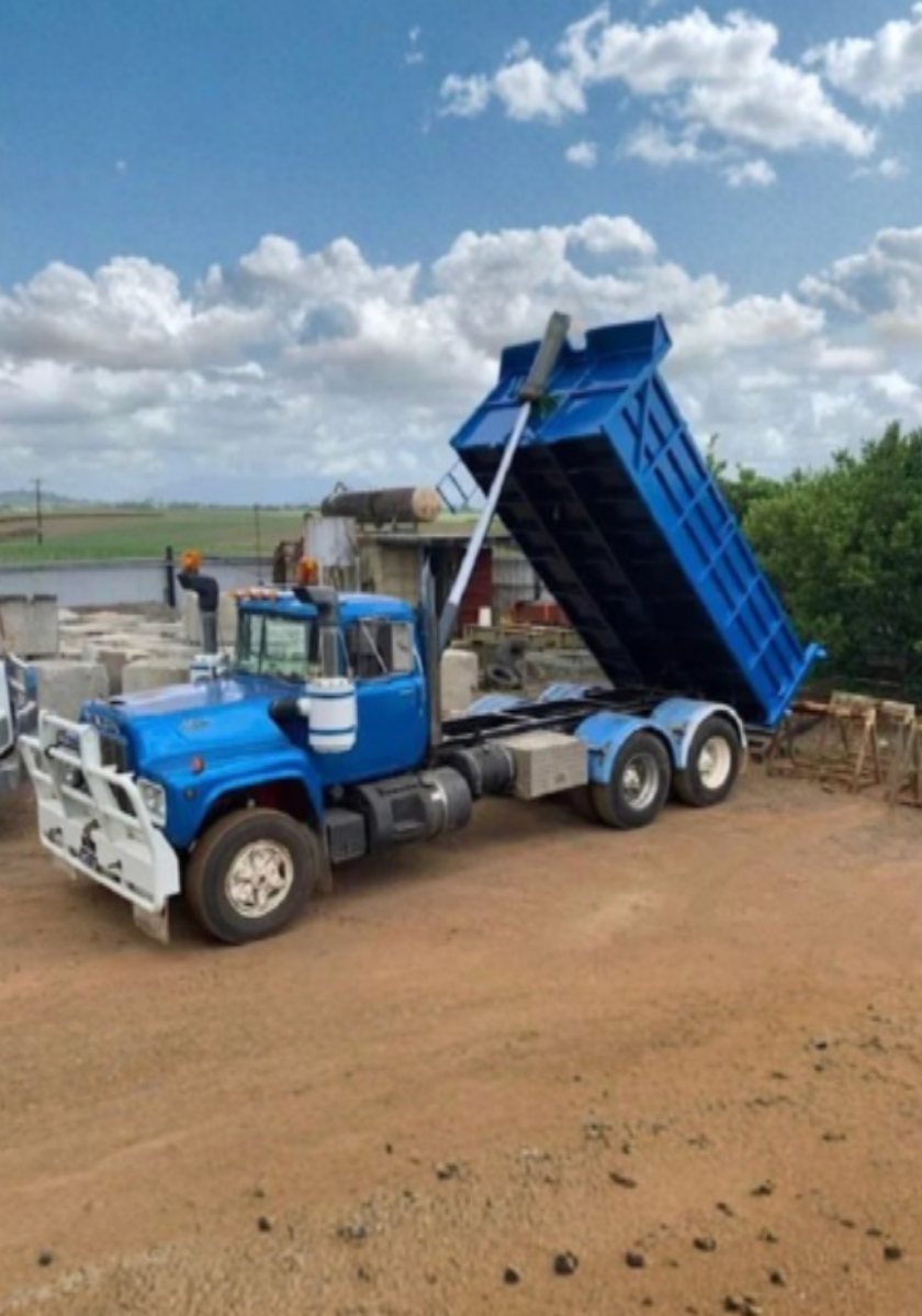Crane Lifting A Yellow Machine Near Sugarcane Fields  — Mears Construction & Training Pty Ltd in South Johnstone, QLD