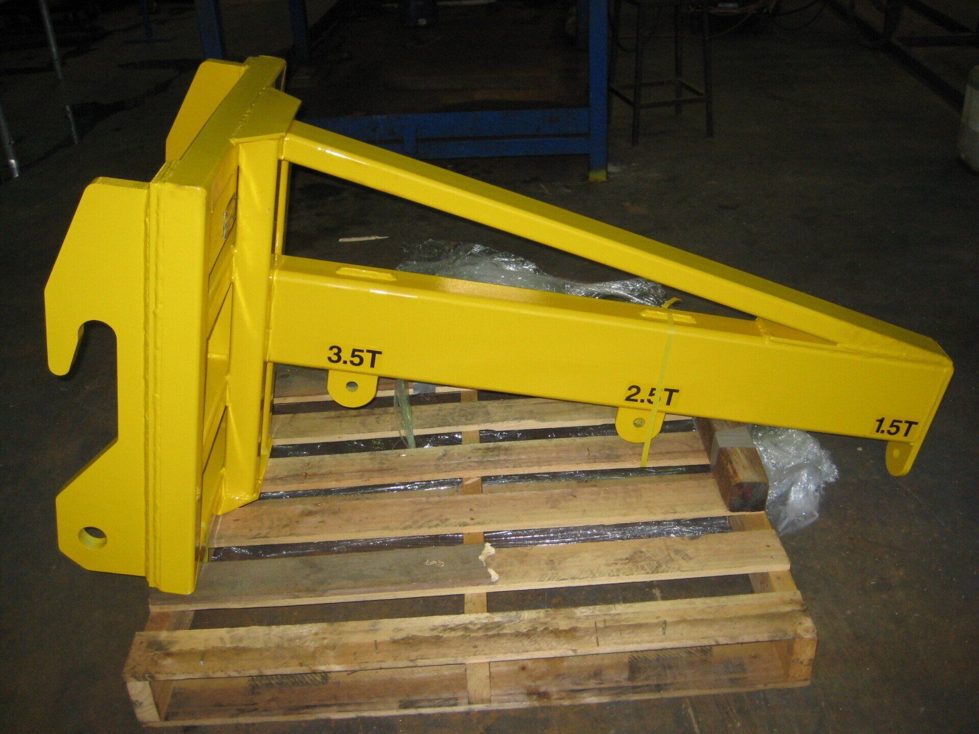 Yellow Crane Fork Attachment On A Wooden Pallet — Mears Construction & Training Pty Ltd in South Johnstone, QLD