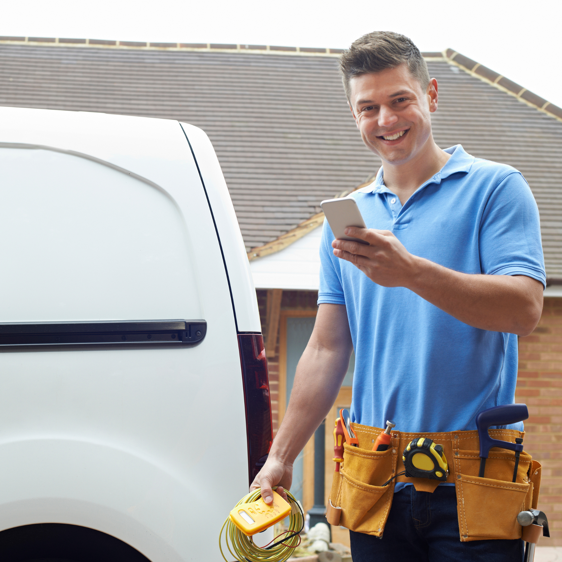 a man is standing in front of a van holding a cell phone .