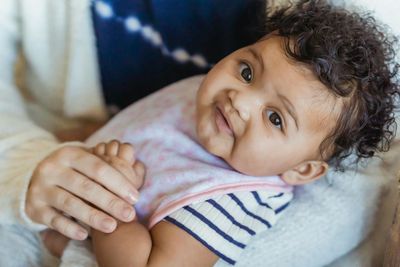 Smiling baby being cared for in a safe and nurturing in-home setting