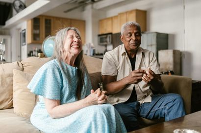Older couple sitting together at home enjoying companionship
