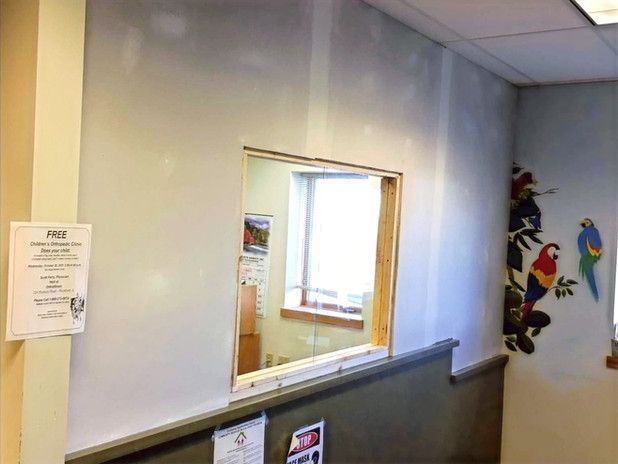 Interior wall with a service window, and a bird mural.