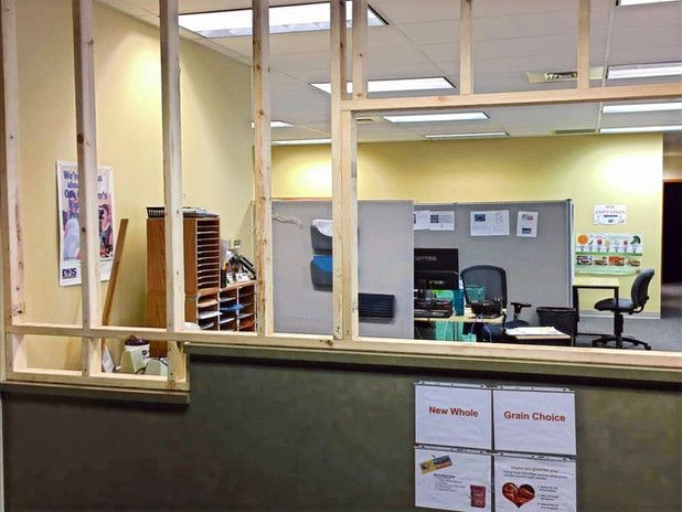 Office space under construction with exposed wooden frame. Interior view of cubicle area.