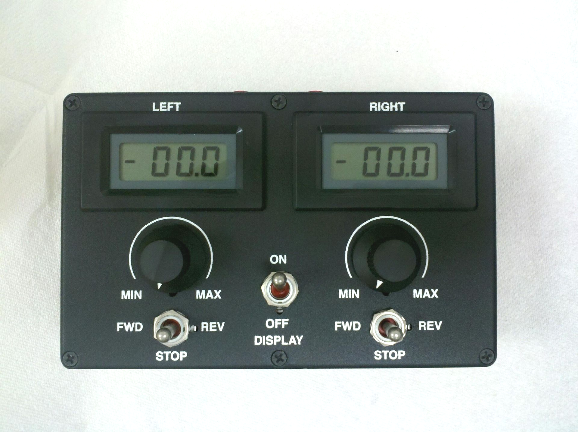 Dual digital control panel with left and right displays, knobs, and stop/start switches on a black faceplate