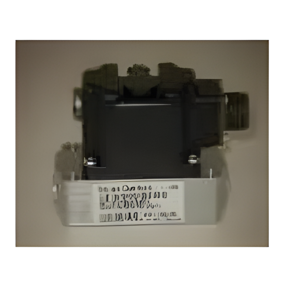 Black electrical component with a white label mounted on a wall
