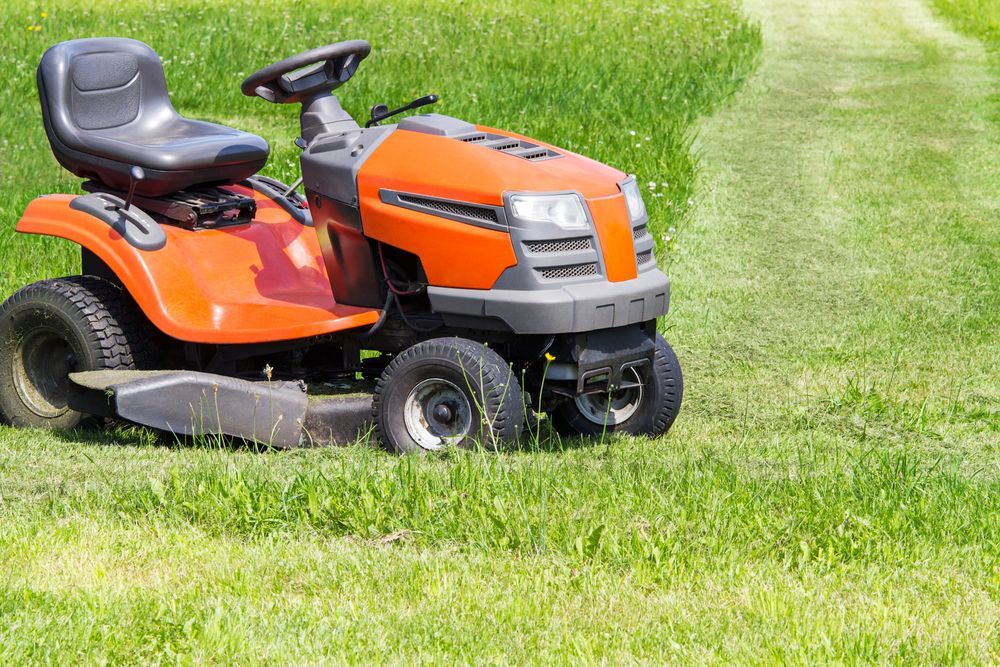 Orange Riding Lawn Mower on Green Grass, Viewed From the Front-left Side — CBS Chainsaw & Brushcutter Specialists - HUSQVARNA in Port Macquarie, NSW