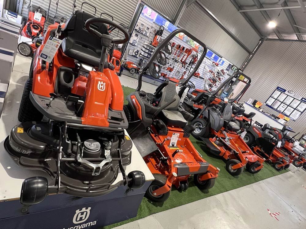 A Row of Lawn Mowers Are Lined up In a Showroom — CBS Chainsaw & Brushcutter Specialists - HUSQVARNA in Wauchope, NSW