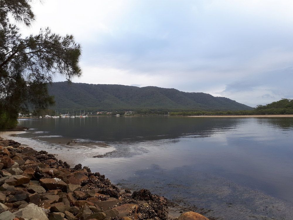 A Large Body of Water With Mountains in the Background — CBS Chainsaw & Brushcutter Specialists - HUSQVARNA in Laurieton, NSW