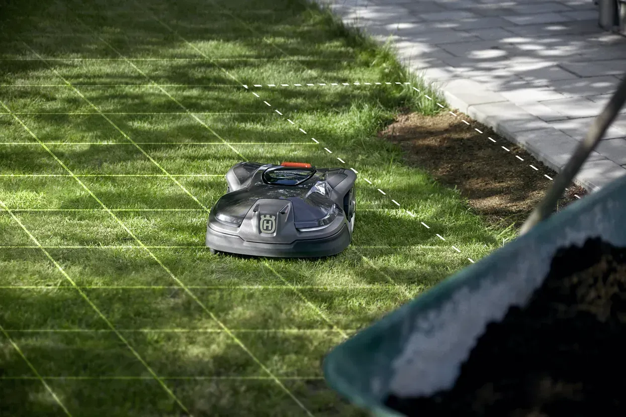 A Robotic Lawn Mower Is Sitting on Top of A Lush Green Lawn — CBS Chainsaw & Brushcutter Specialists - HUSQVARNA in Wauchope, NSW