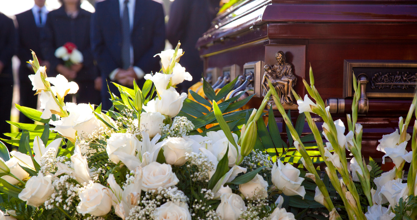 Funeral flowers during a eulogy that was written meaningfully
