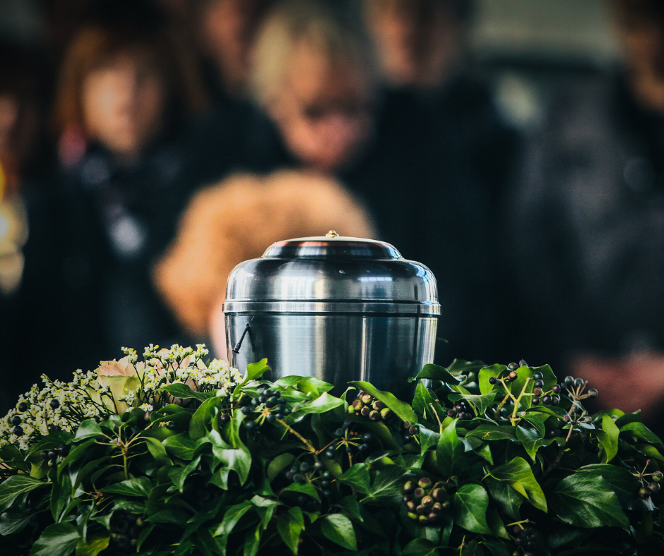 Urn sitting inside a flower arrangement during funeral services near Coon Valley, WI.