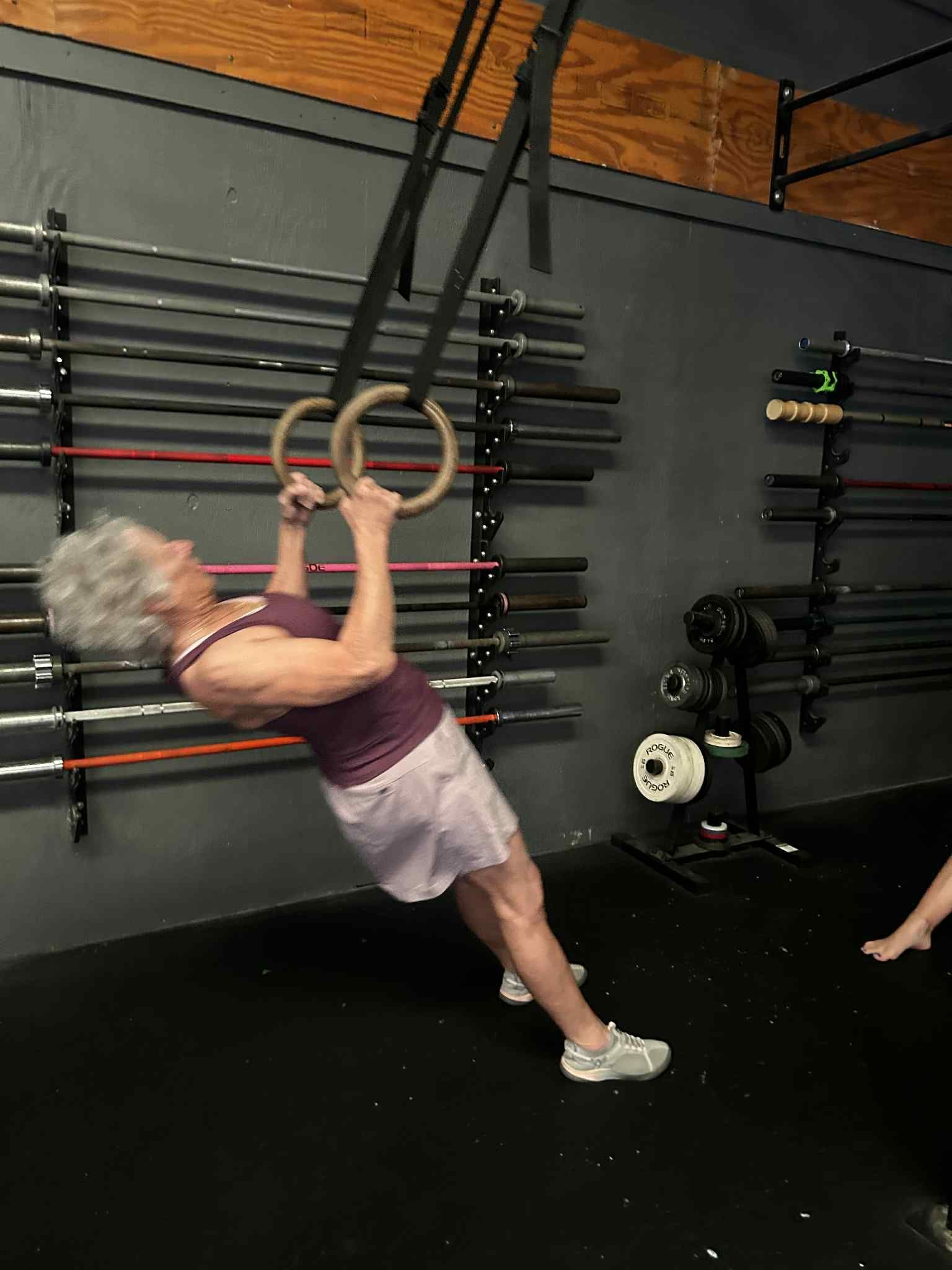 A Training Lab member performing a ring row during a training session in Easley