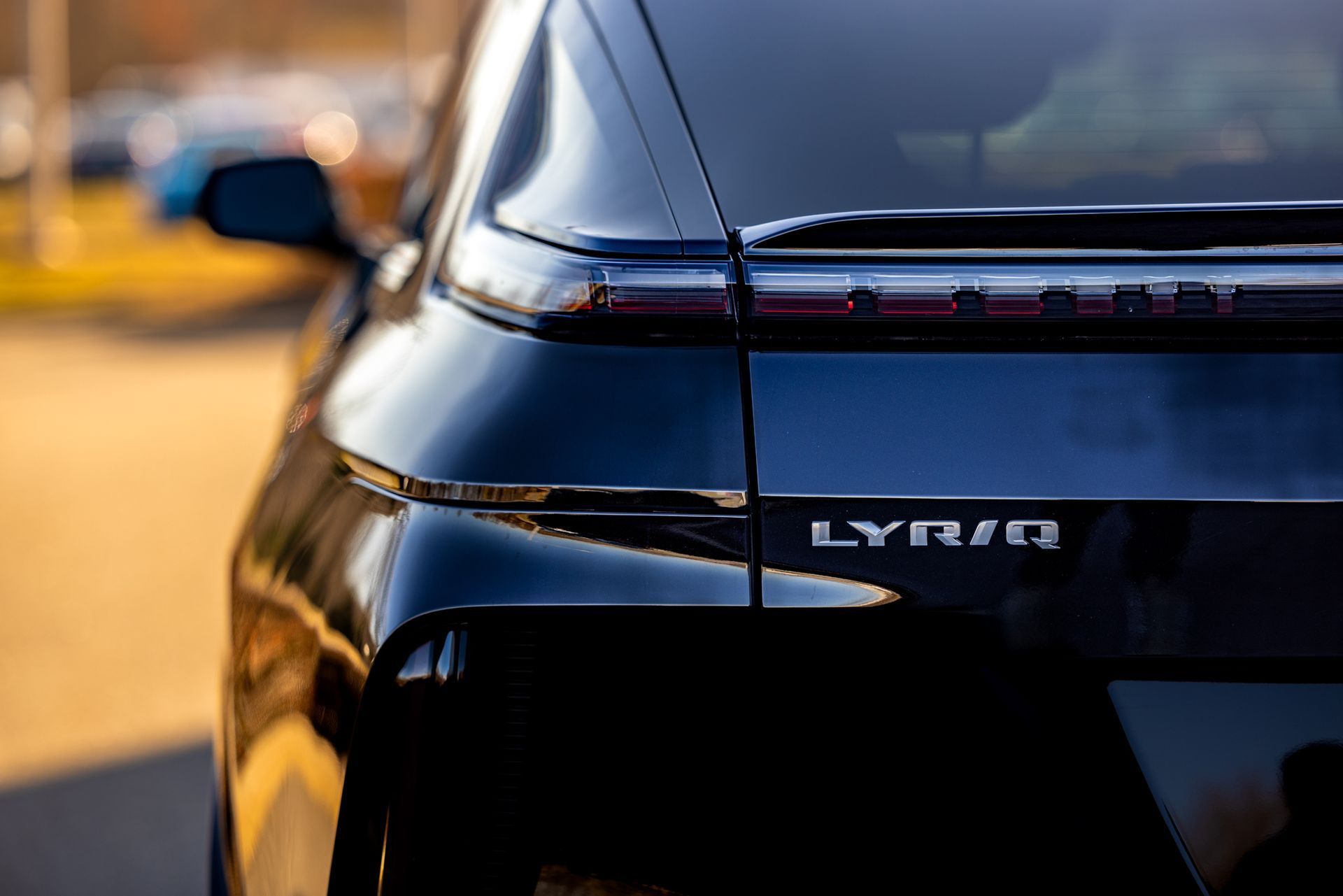 The rear end of a black lyriq is shown in a close up.