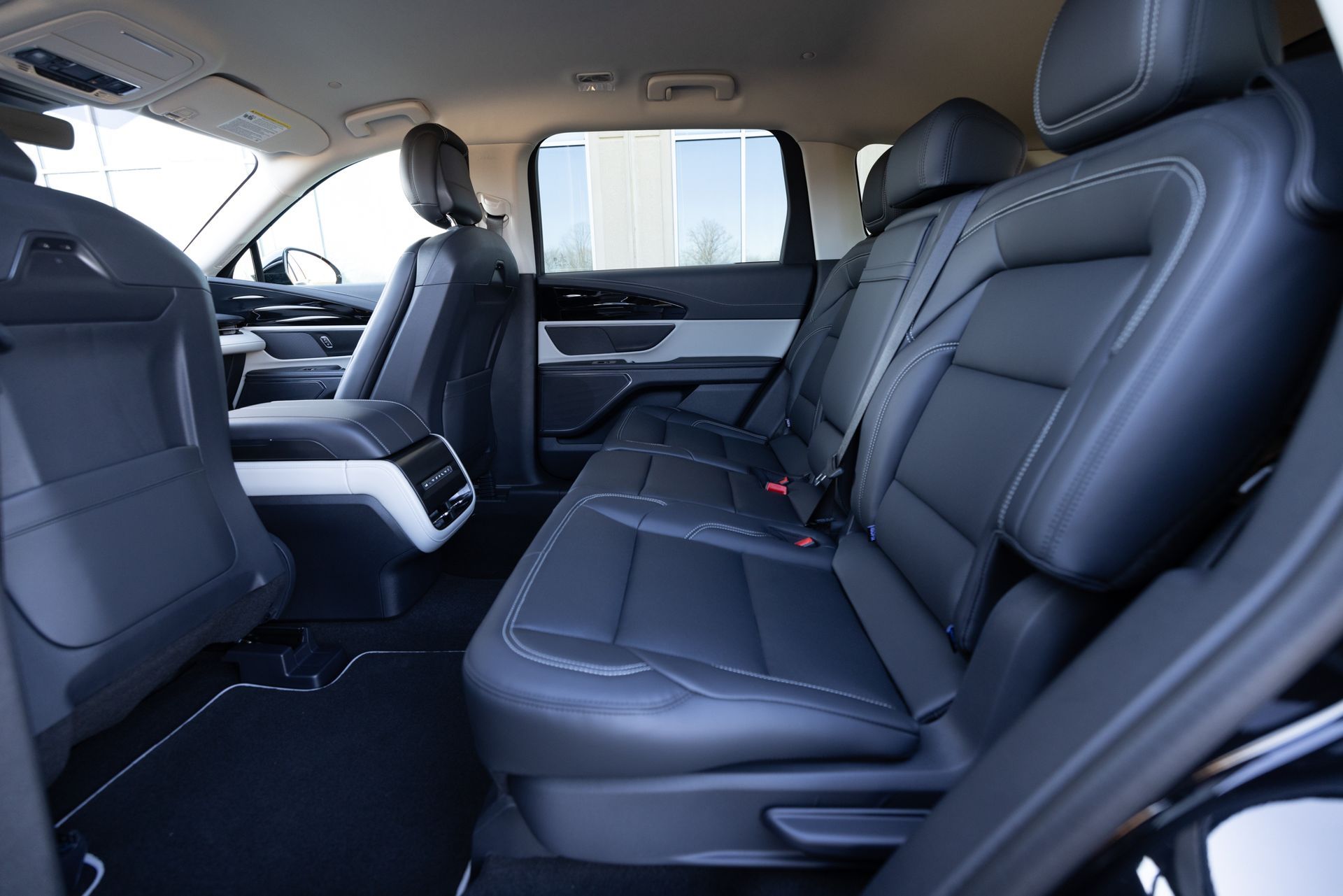 The rear seats of a black car are empty.