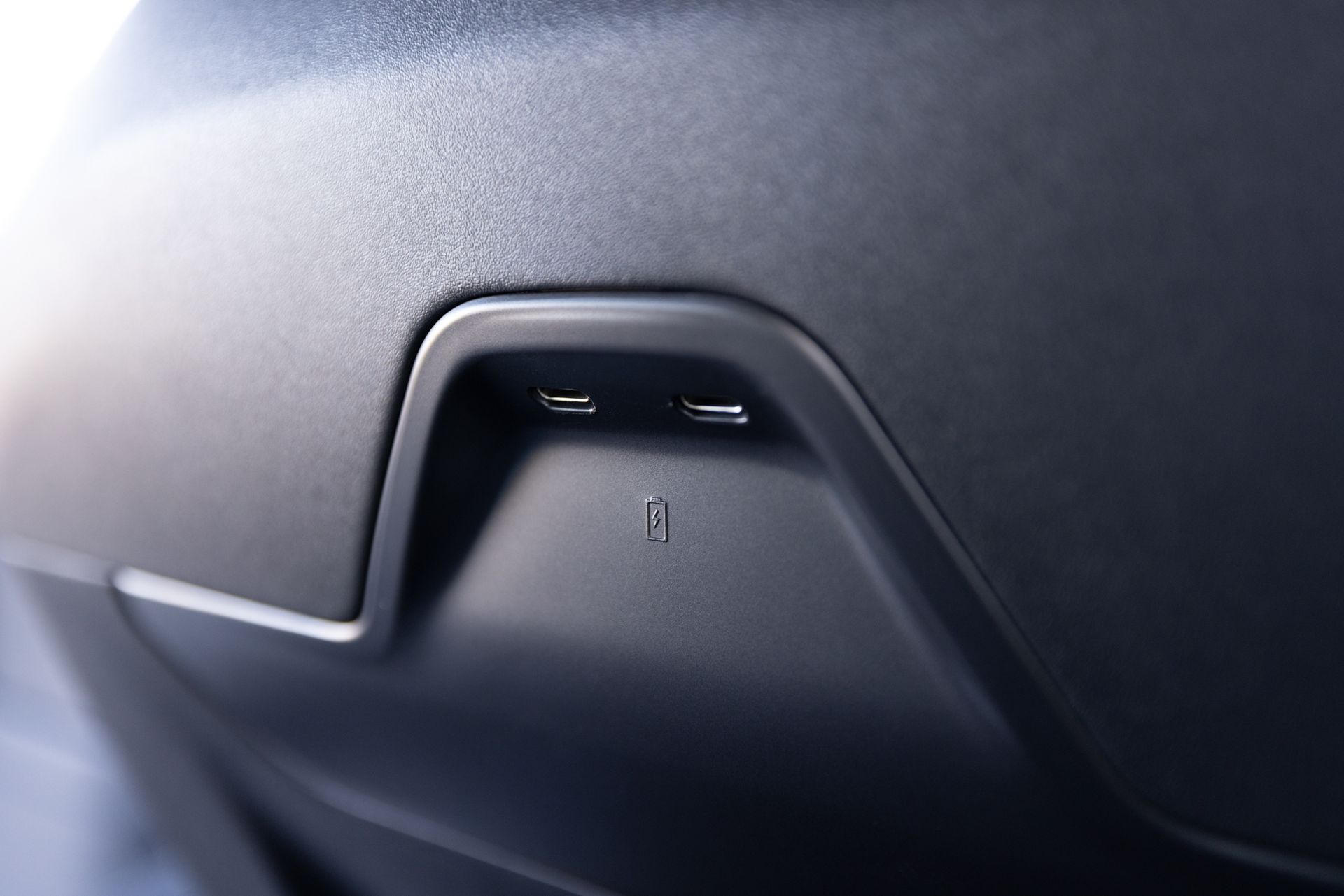 A close up of a car door with a usb port