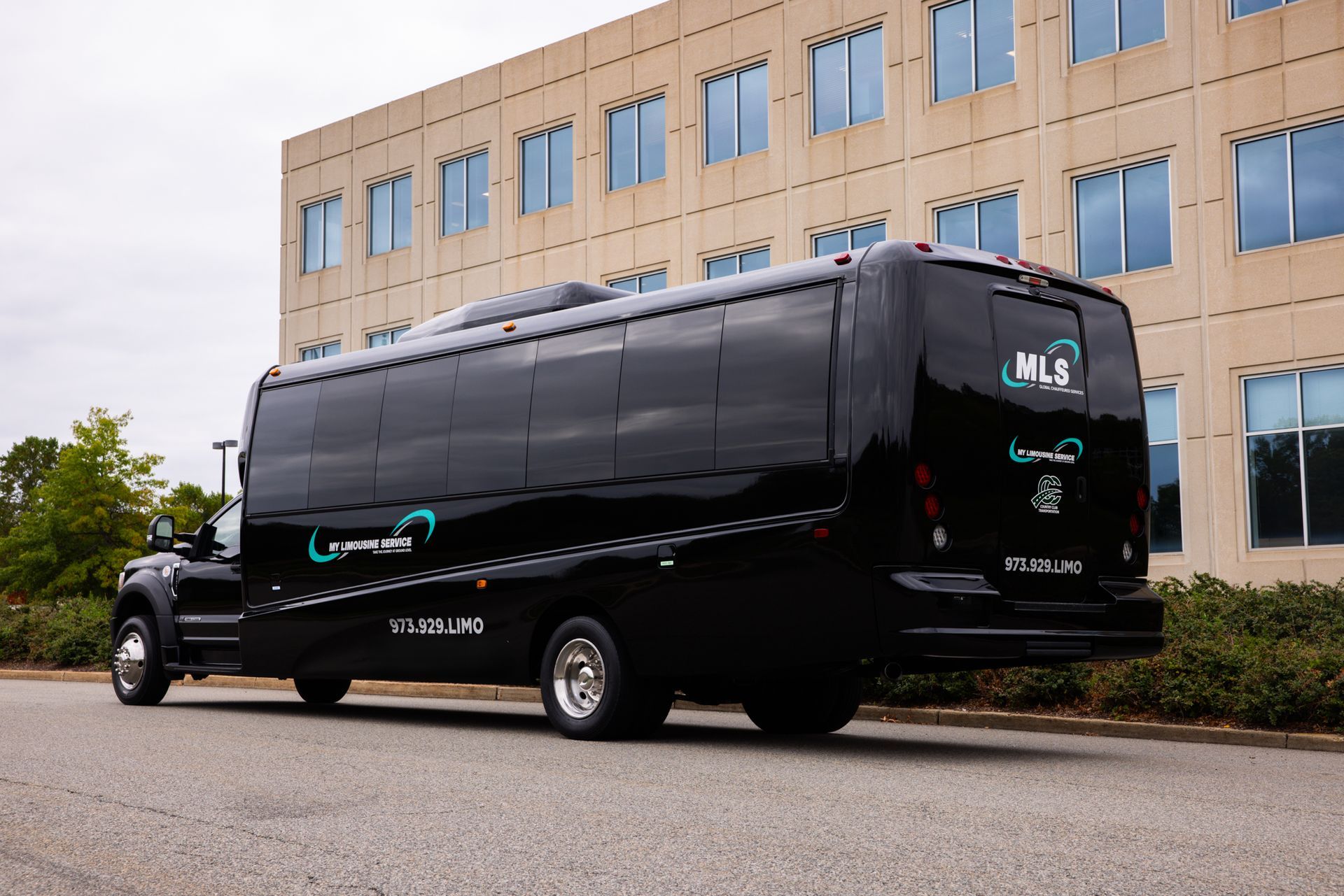 Exterior view of black minibus with My Limo branding.