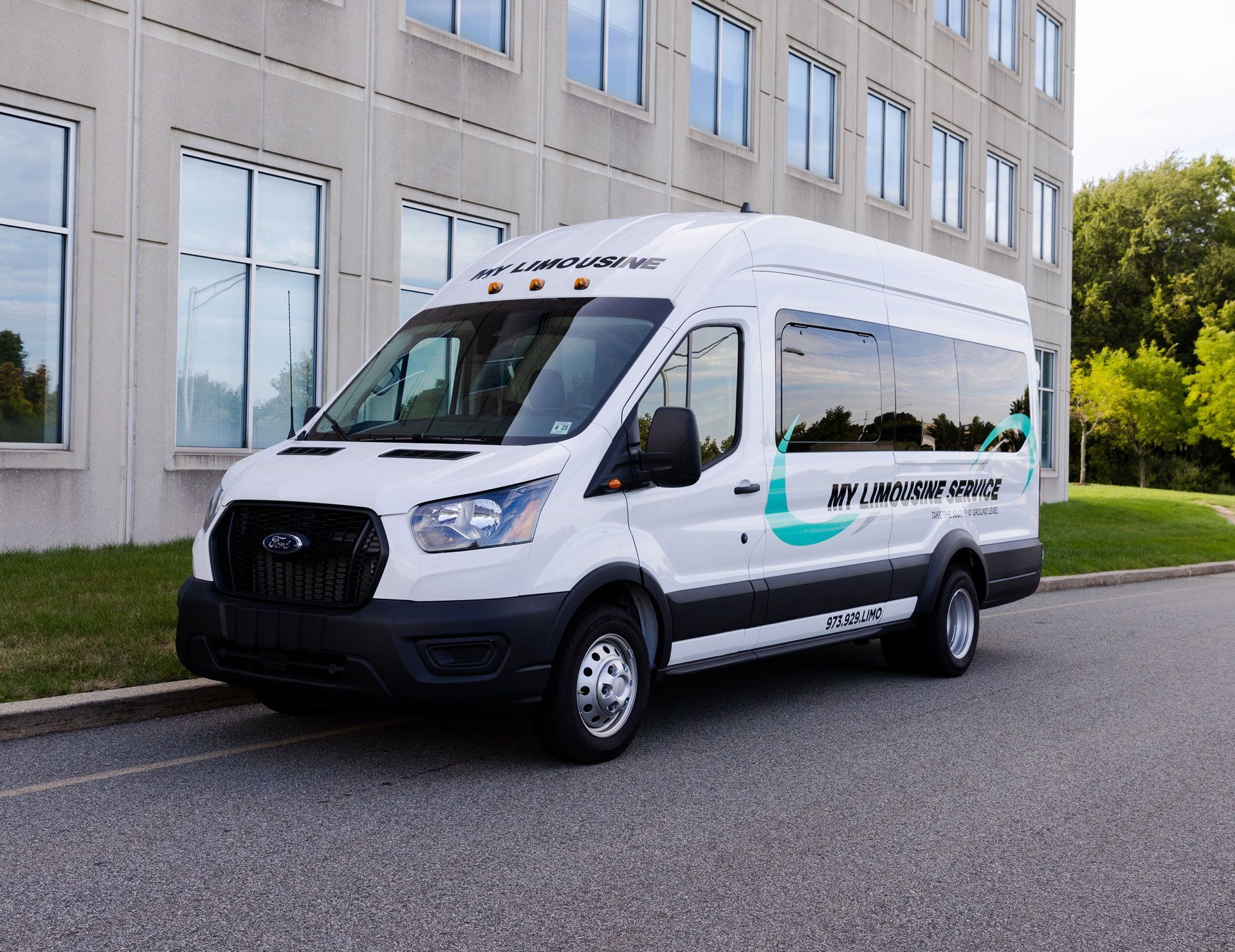 A white van is parked in front of a building.