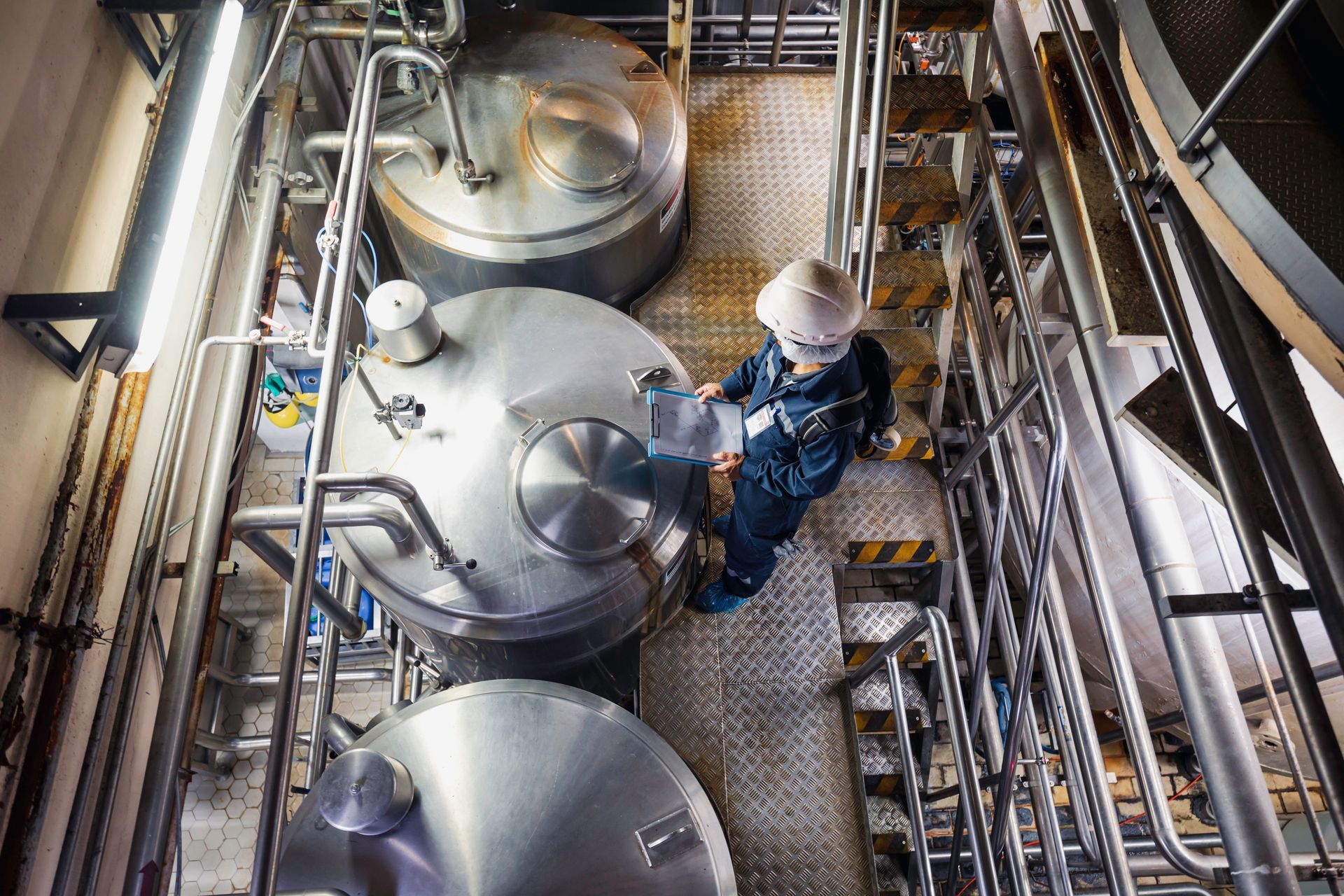 A man is working on a machine in a factory.