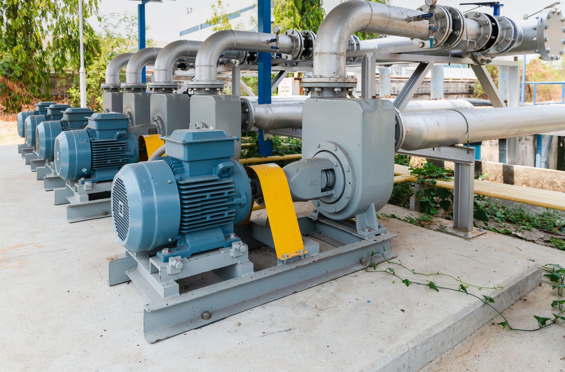 Four identical wastewater pumps tied into a common discharge header at a municipal treatment plant